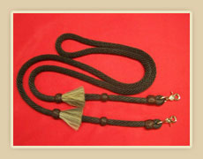 Poly roping rein with coffee colored rawhide braided knots and horsehair tassles