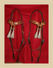 Matching set of headstalls crossed browband with horse hair tassles and rawhide braiding