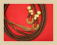 7 1/2 ft. Braided Latigo split reins, with Rawhide knots and quick detachable ends.