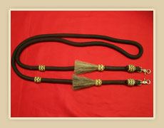Poly roping rein with horse hair tassles and rawhide knots with color string and sissor snaps