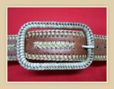 Custom made belt buckle with rawhide braid.