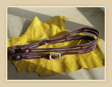 One ear headstalls with rawhide accents and buckles