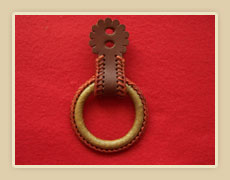 Rawhide covered hobble ring with colored string