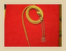 Leather split reins with rawhide knots and ball chains