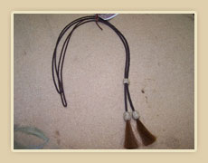 Leather stampede strings with rawhide knots and horse hair