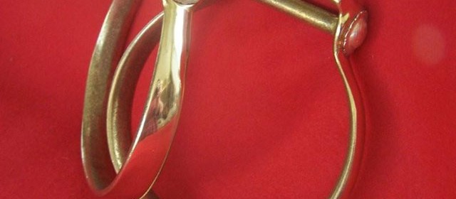Brass oxbow stirrups with sterling silver conchos