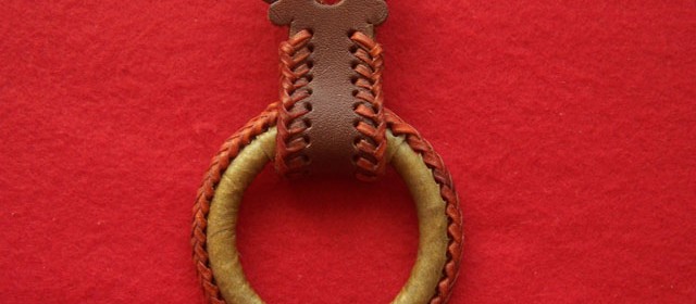 Rawhide covered hobble ring with colored string