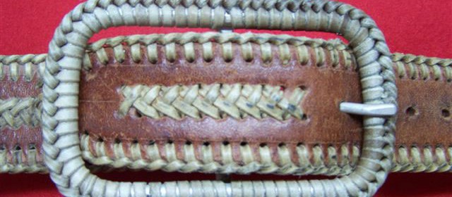 Custom made belt buckle with rawhide braid.